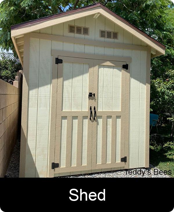 Picture of a teddys Beekeeper removing a  beehive from a shed floor. nav link image